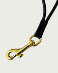 Close up of solid brass trigger hook on Wildgrain Leather Essential Loop Wrist Strap in Black.