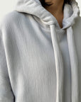 Detail of double layered hood with a thick drawstring on Organic Contoured Cotton A.D.C. Hoodie in Porcelain.