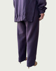 Rear view of gently gathered hem with side slits on Organic Contoured Cotton A.D.C. Hoodie in Evening Violet, styled with Organic Contoured Cotton Arc Pant in Evening Violet.