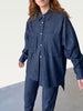 Hoi  bo Fall 2022 Denim Button Up Shirt with a high-low hemline and mother of pearl buttons