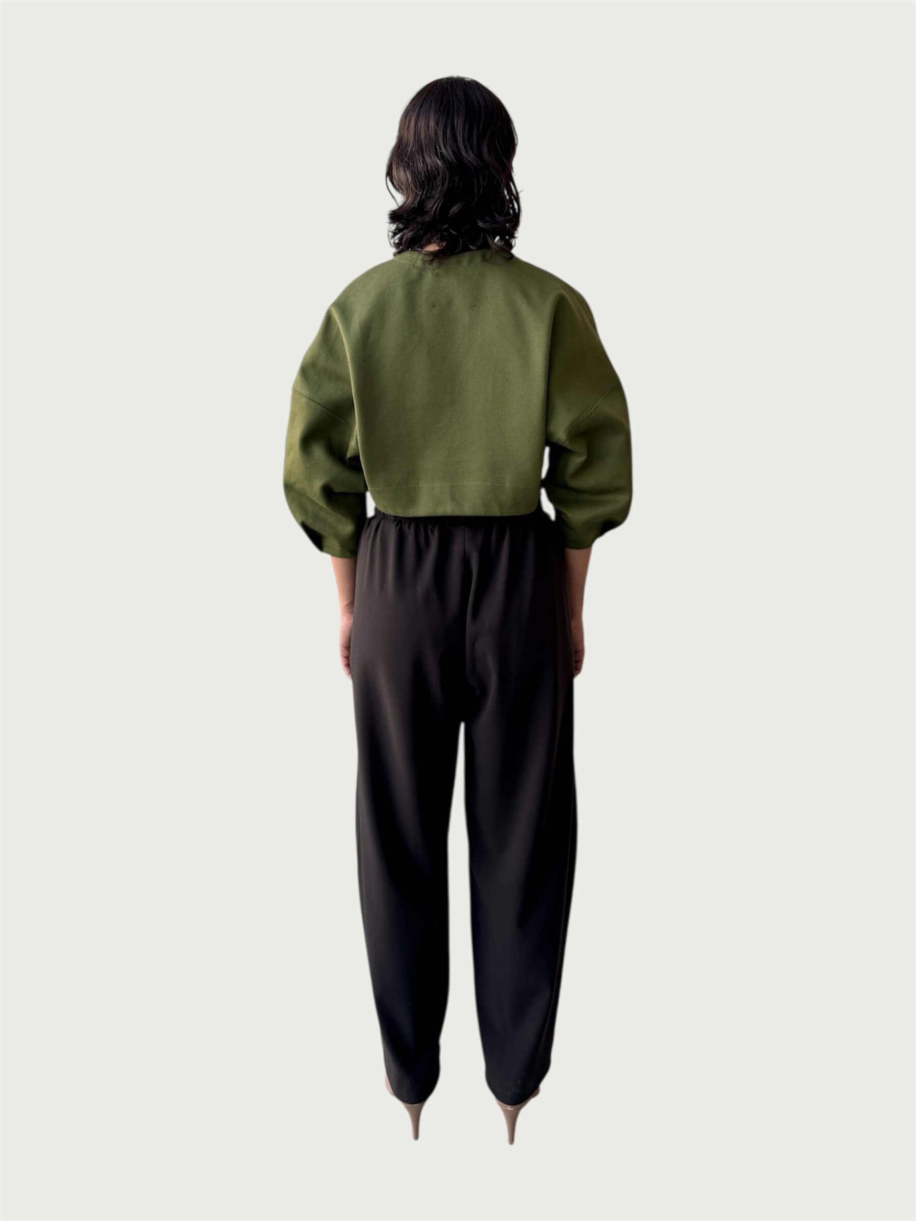 Rear view of Contoured Bolero Jacket in Lucid Olive highlighting the cropped hem and dropped shoulder, styled with Wool Suiting Arc Pant in Espresso Brown.