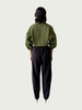 Rear view of Contoured Bolero Jacket in Lucid Olive highlighting the cropped hem and dropped shoulder, styled with Wool Suiting Arc Pant in Espresso Brown.