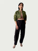 Model in Contoured Bolero Jacket in Lucid Olive with cropped contoured hem and three-quarter sleeves, styled with Wool Suiting Arc Pant in Espresso Brown.