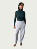 Model in Ribbed Mock Neck Shirttail Top in Silver Pine with long sleeves and a close, body-skimming fit, styled with the Organic Contoured Cotton Arc Pant in Porcelain.