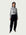 Model in Ribbed Mock Neck Shirttail Top in Dove Grey with long sleeves and a close, body-skimming fit, styled with the Organic Contoured Cotton Arc Pant in Black.