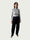Model in Ribbed Mock Neck Shirttail Top in Dove Grey with long sleeves and a close, body-skimming fit, styled with the Organic Contoured Cotton Arc Pant in Black.