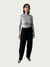 Model in Ribbed Mock Neck Shirttail Top in Dove Grey with long sleeves and a close, body-skimming fit, styled with the Organic Contoured Cotton Arc Pant in Black.