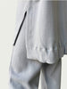 Detail of high-low hemline with side slit on Organic Contoured Cotton A.D.C. Hoodie in Porcelain.