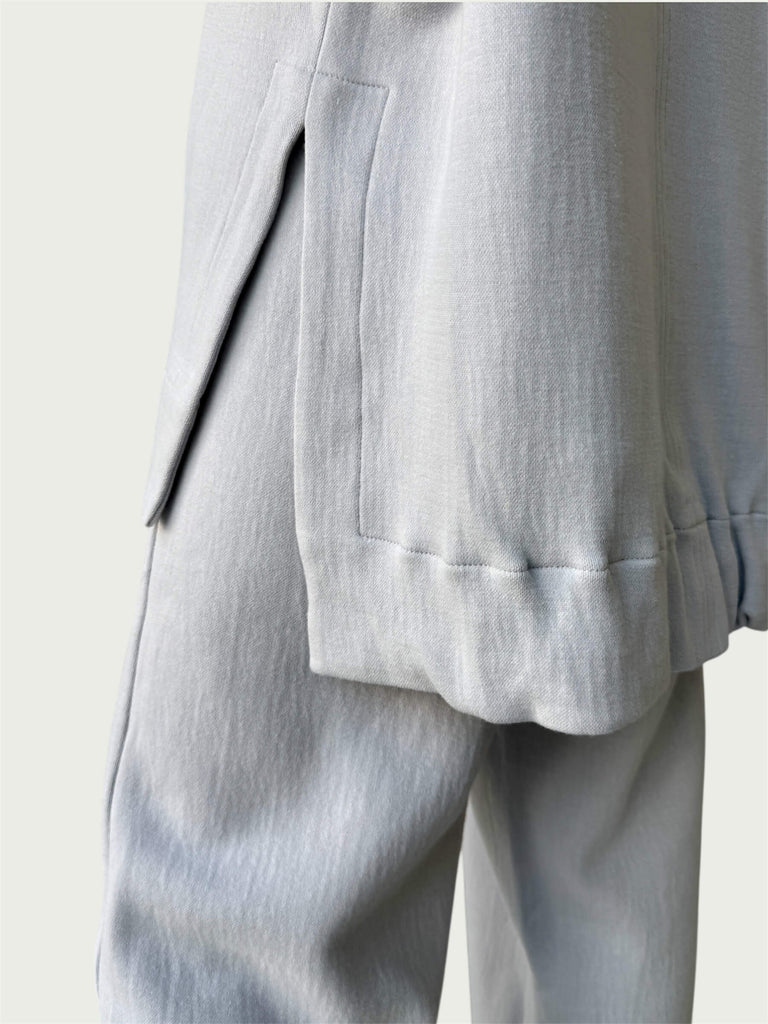 Detail of high-low hemline with side slit on Organic Contoured Cotton A.D.C. Hoodie in Porcelain.