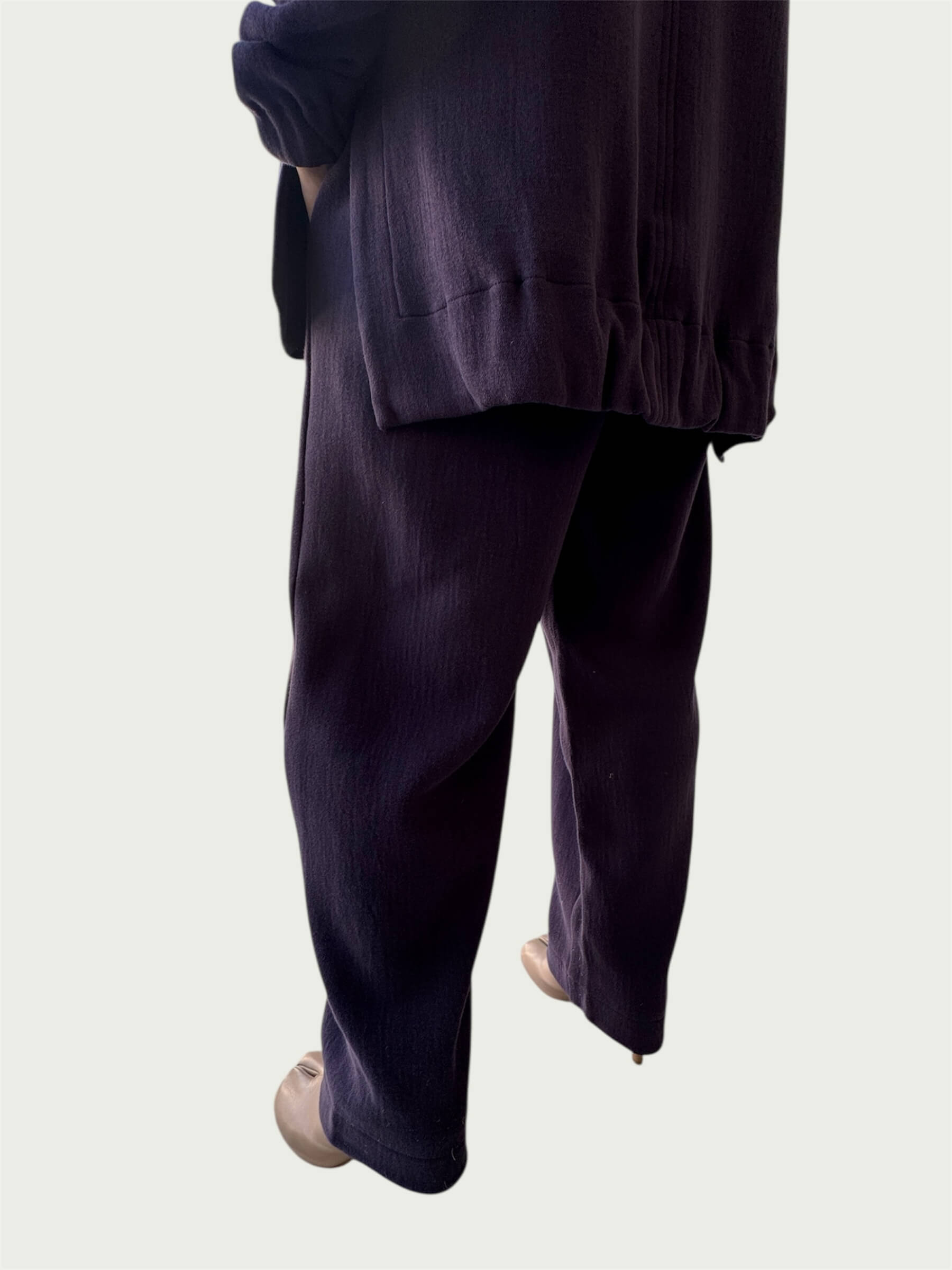 Rear view of gently gathered hem with side slits on Organic Contoured Cotton A.D.C. Hoodie in Evening Violet, styled with Organic Contoured Cotton Arc Pant in Evening Violet.