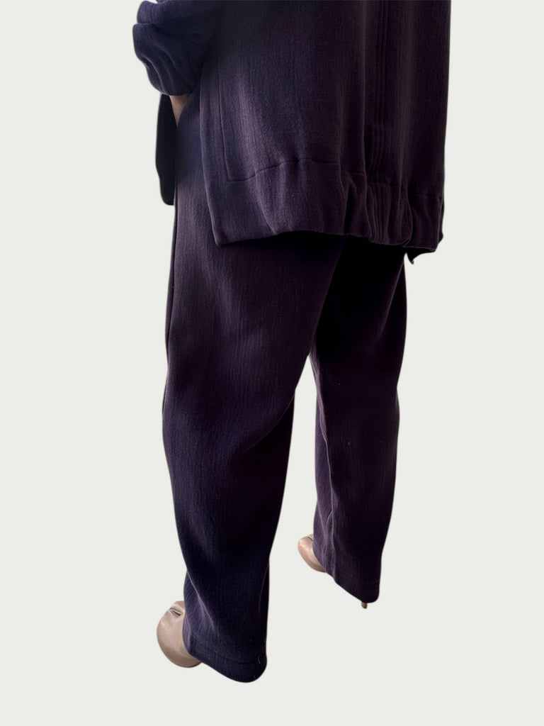Rear view of gently gathered hem with side slits on Organic Contoured Cotton A.D.C. Hoodie in Evening Violet, styled with Organic Contoured Cotton Arc Pant in Evening Violet.
