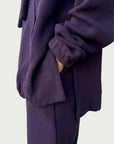 Detail of high-low hemline with side slit on Organic Contoured Cotton A.D.C. Hoodie in Evening Violet, showcasing its easy drape and pant pocket access through side slit.