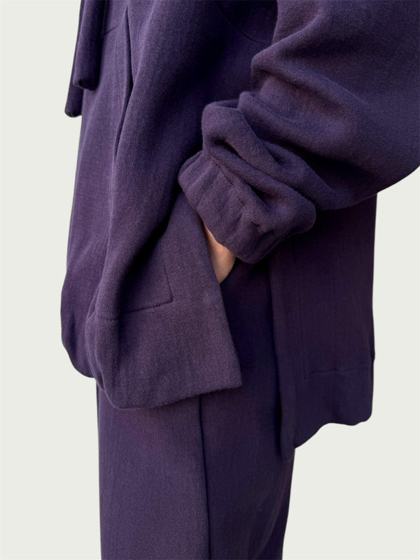 Detail of high-low hemline with side slit on Organic Contoured Cotton A.D.C. Hoodie in Evening Violet, showcasing its easy drape and pant pocket access through side slit.