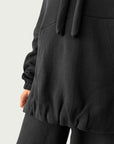 Detail of in-seam Kangaroo pocket and stacked sleeve on Organic Contoured Cotton A.D.C. Hoodie in Black,