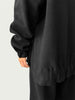 Detail of high-low hemline with side slit on Organic Contoured Cotton A.D.C. Hoodie in Black, showcasing its easy drape.