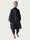 Person wearing a dark coat and pants on a white background