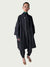 Person wearing a dark coat and pants on a white background