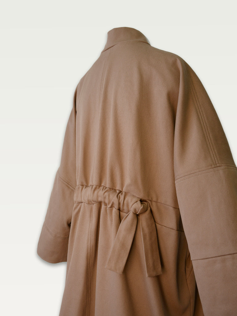 Hoi bo Fall 2022 cotton twill, knee length coat in Camel colour - gathered back detail 